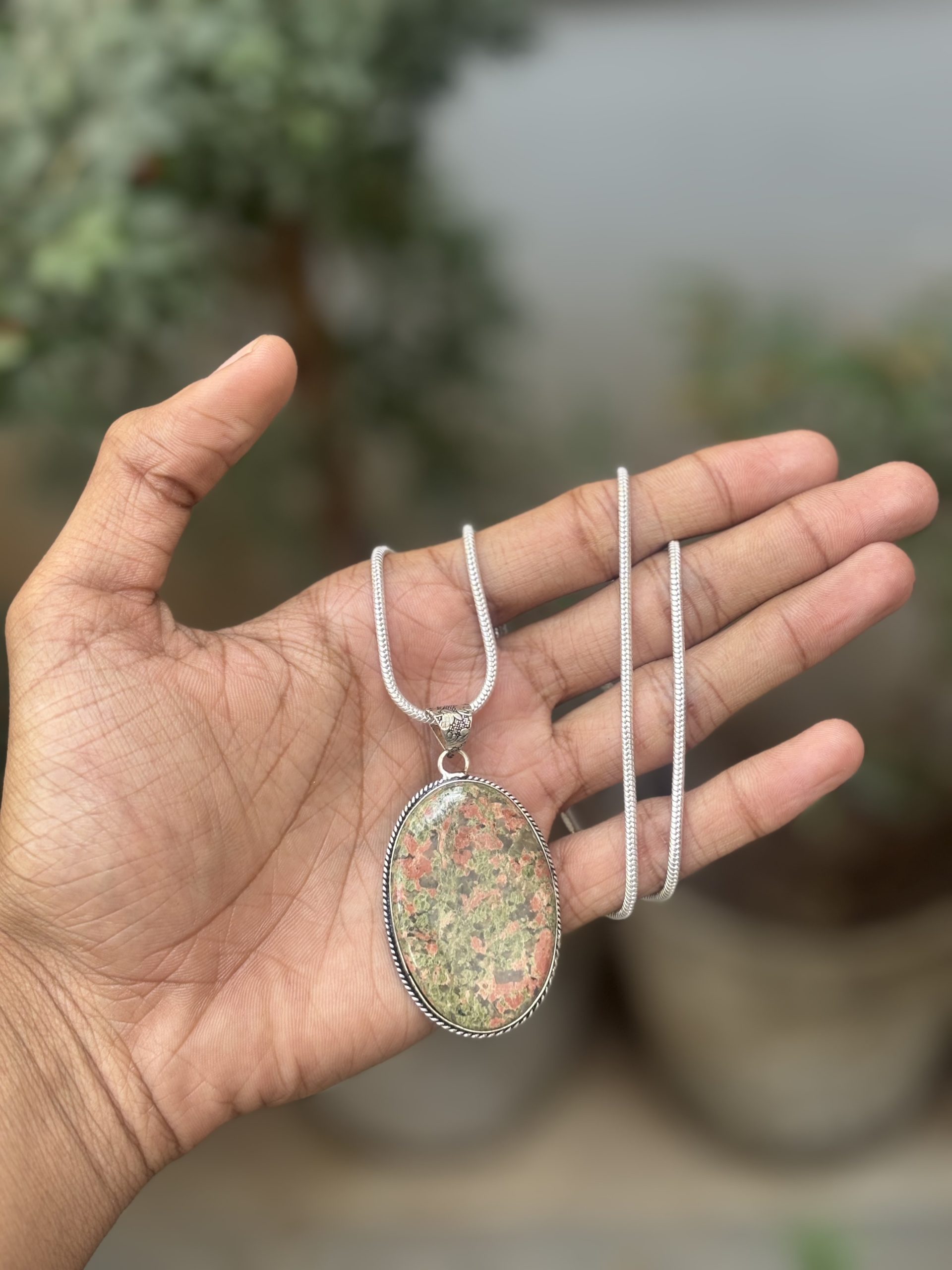 Unakite Pendant with Chain – Lab Certified Natural Healing Crystal Necklace Discover balance, healing, and natural beauty with this elegant Unakite Pendant with Chain, crafted using a lab certified natural Unakite stone. Known for its beautiful blend of green and pink tones, Unakite is a natural stone composed mainly of epidote, feldspar, and quartz, admired for its grounding energy and emotional healing symbolism. Perfect for meditation, healing practices, or stylish everyday wear, this pendant combines earthy elegance with meaningful spiritual energy. image 2