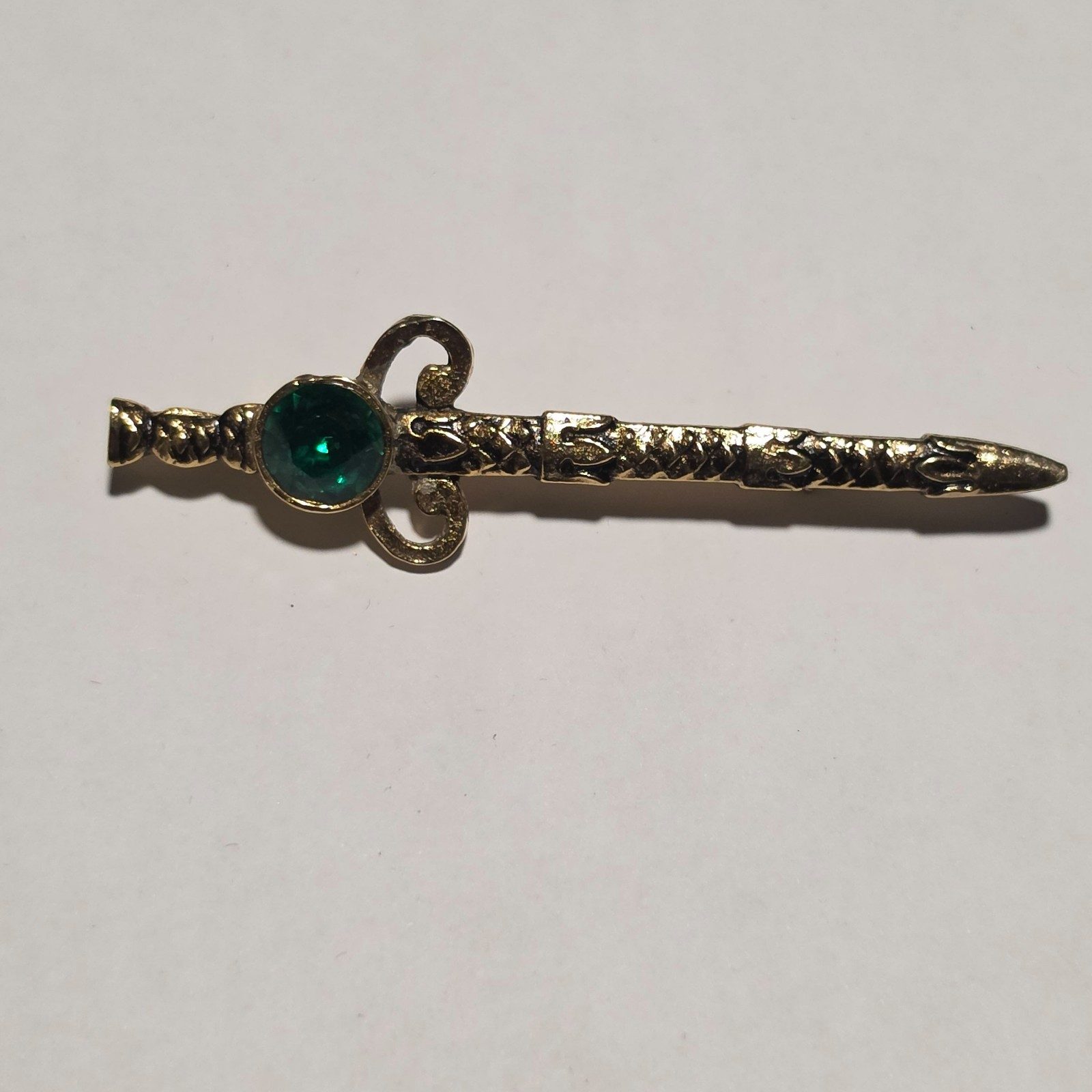 Gold Tone Sword Brooch with Green Gem